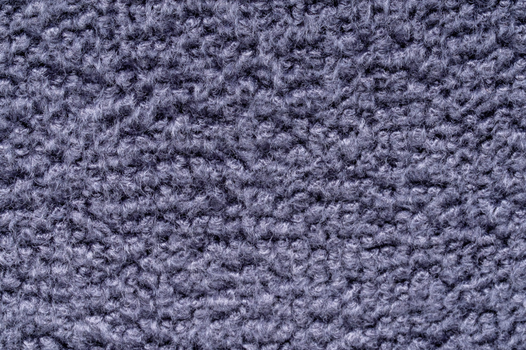 A close-up texture shot of UNS Microfiber towel showing the dense fibers and color