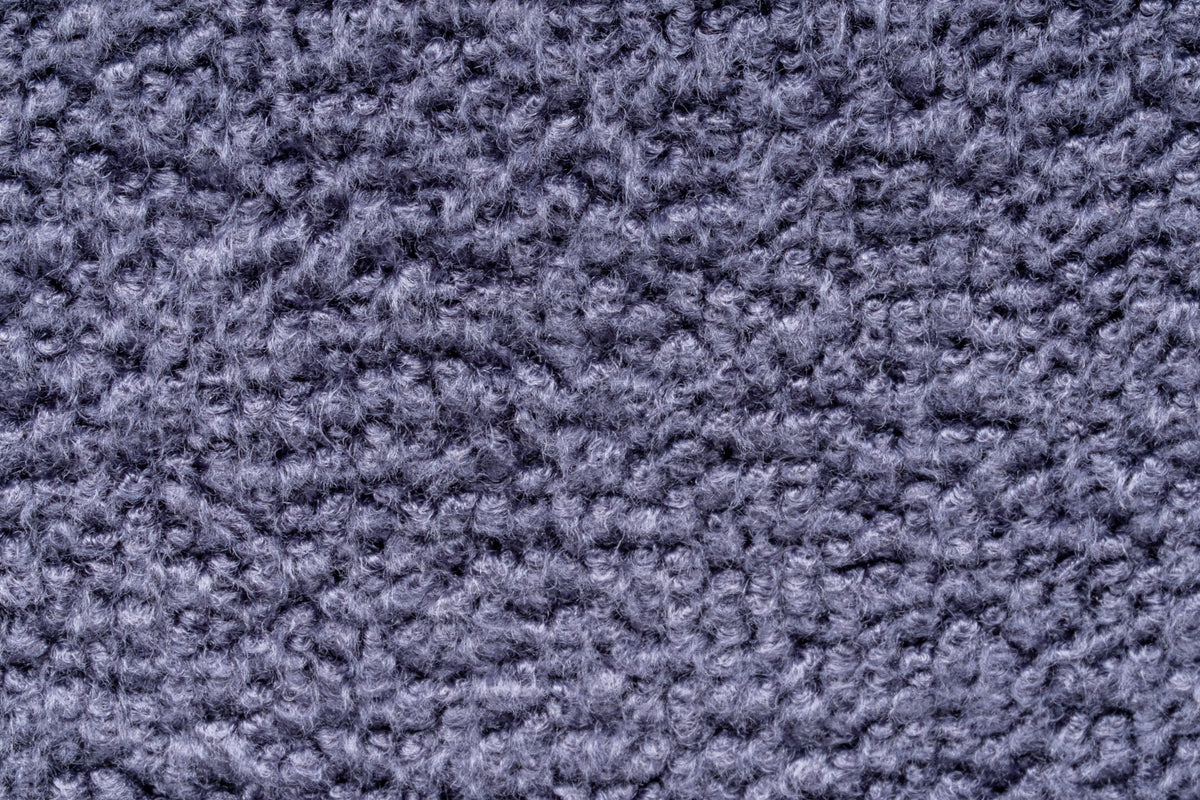 A close-up texture shot of UNS Microfiber towel showing the dense fibers and color